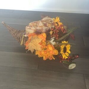 Cornucopia horn shaped wicker basket filled with flowers